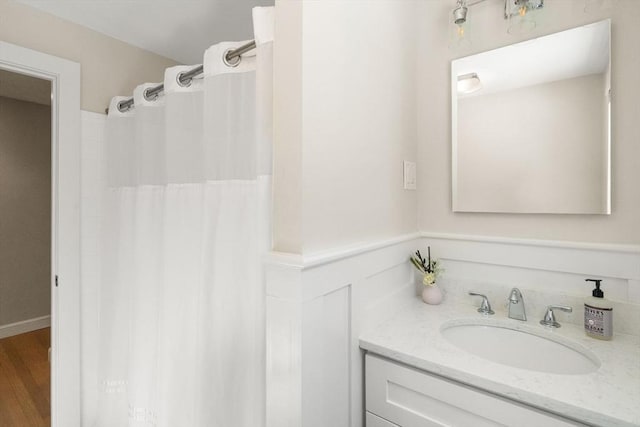 full bathroom featuring wood finished floors and vanity