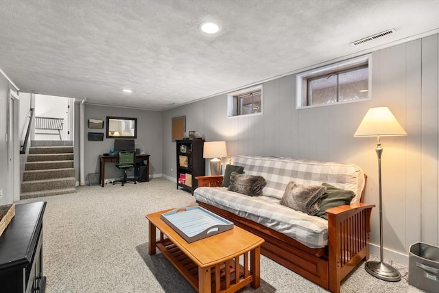 carpeted living room featuring baseboards, visible vents, stairs, a textured ceiling, and recessed lighting