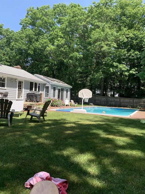 view of yard with fence and a fenced in pool