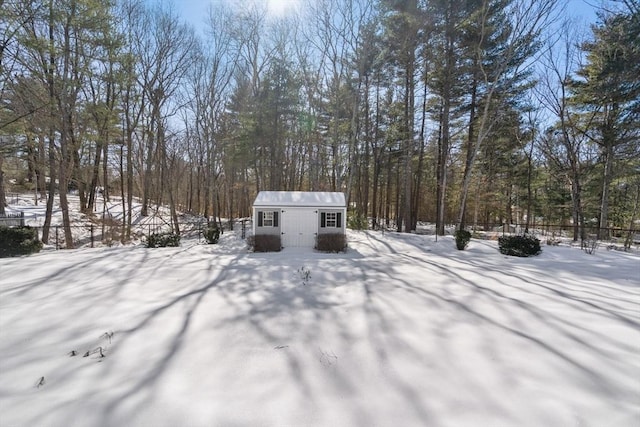 yard layered in snow featuring an outbuilding