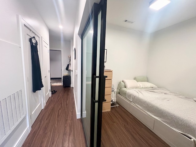 bedroom with dark wood-type flooring