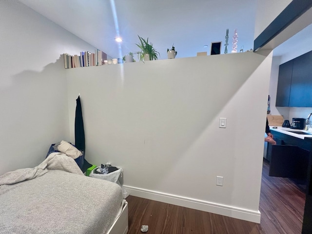 bedroom with dark hardwood / wood-style flooring