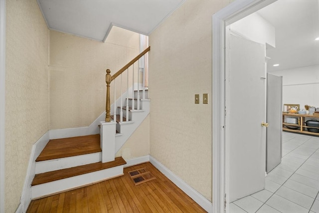 stairs featuring hardwood / wood-style floors