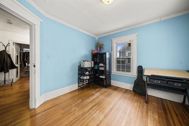 home office featuring wood-type flooring and ornamental molding