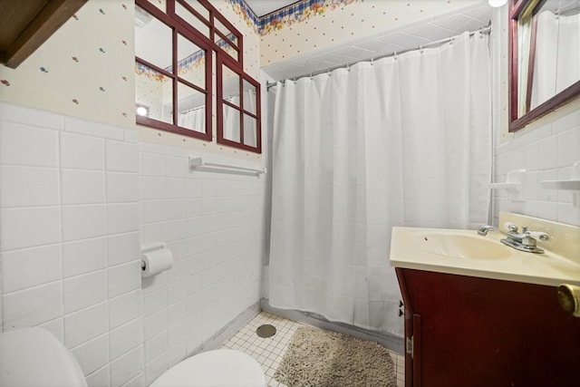 bathroom featuring toilet, tile walls, vanity, a shower with shower curtain, and tile patterned flooring