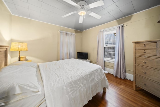 bedroom featuring ceiling fan and dark hardwood / wood-style flooring