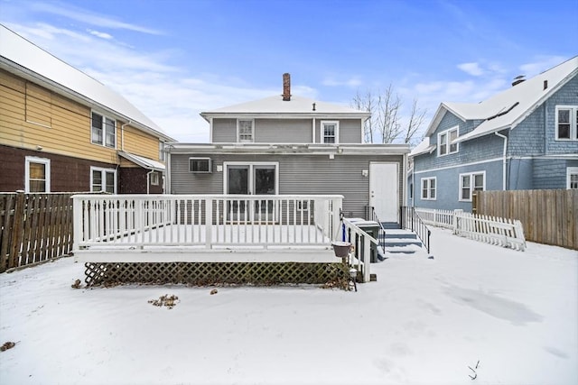 snow covered property featuring a deck