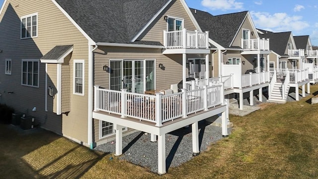 rear view of property with a lawn and a wooden deck