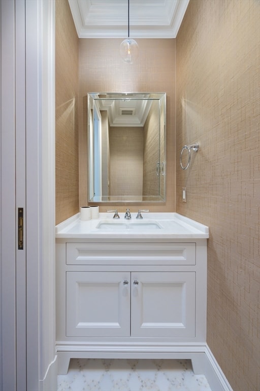 bathroom featuring crown molding and vanity