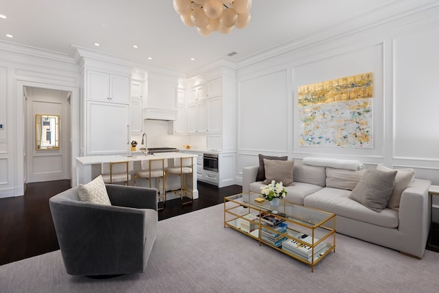 living room featuring ornamental molding and dark wood-type flooring