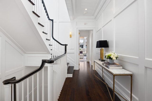 hall with dark hardwood / wood-style flooring and ornamental molding