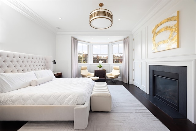 bedroom with ornamental molding and dark wood-type flooring