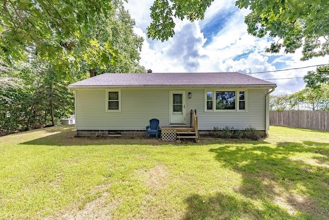 rear view of property with a lawn