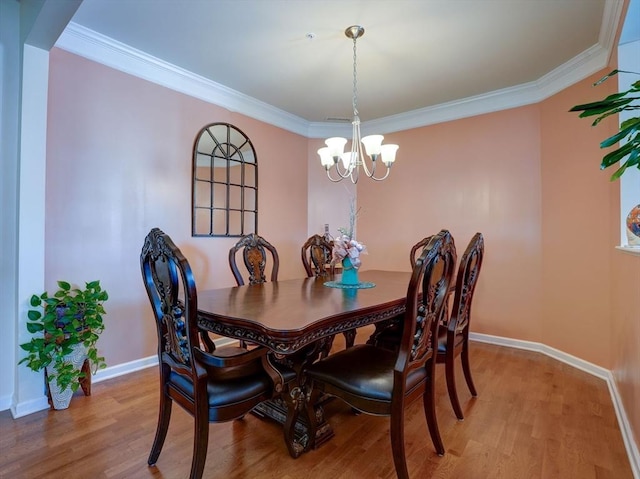 dining room with baseboards, a chandelier, light wood-style flooring, and crown molding