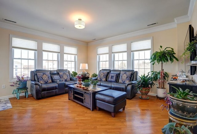 living area with light wood-type flooring, baseboards, visible vents, and ornamental molding