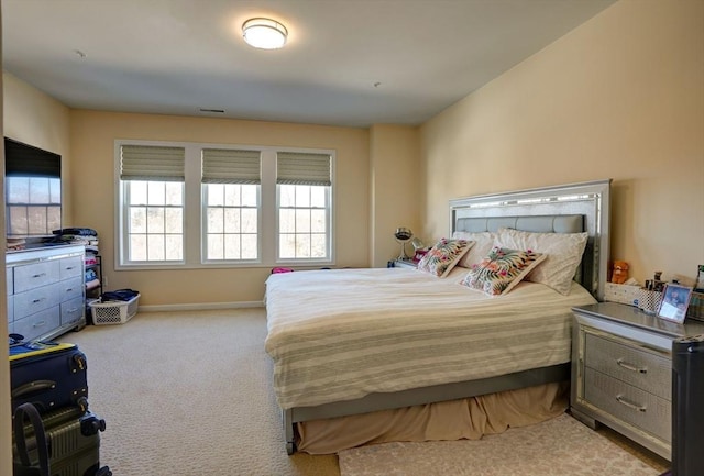 carpeted bedroom with visible vents and baseboards