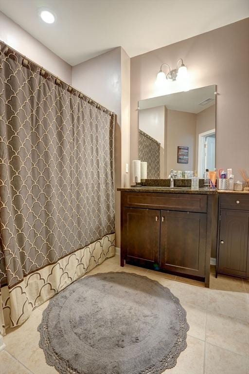 full bath featuring tile patterned flooring, vanity, and a shower with curtain