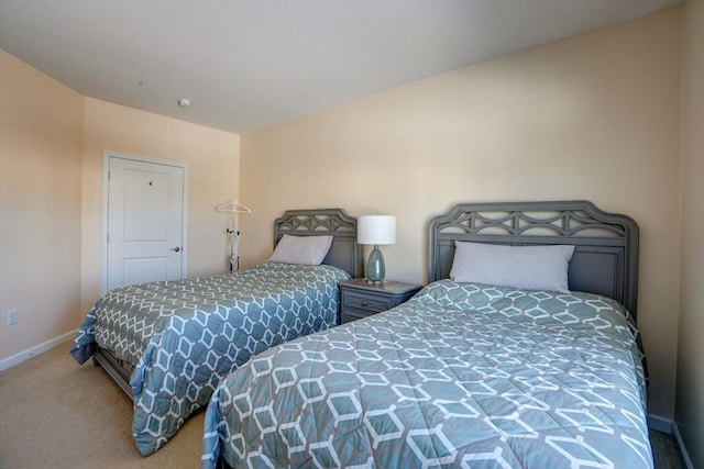 carpeted bedroom featuring baseboards