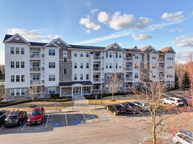 view of property featuring uncovered parking