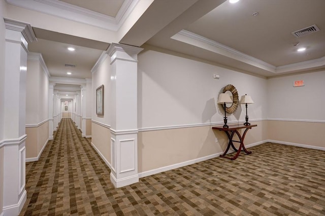 hallway featuring carpet, decorative columns, visible vents, and ornamental molding