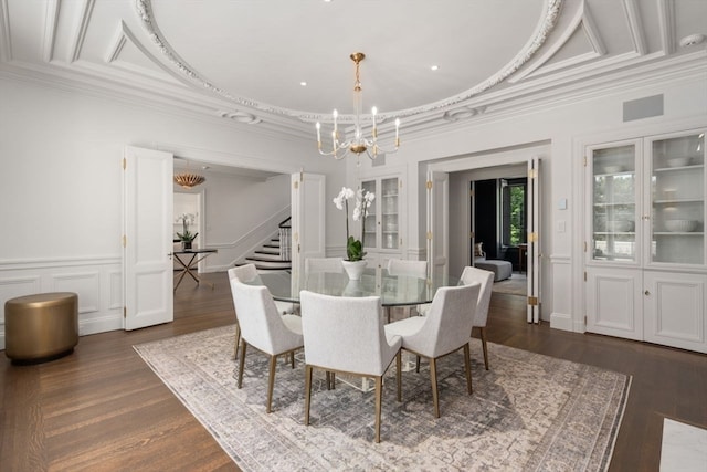 dining area featuring an inviting chandelier, dark hardwood / wood-style flooring, and ornamental molding