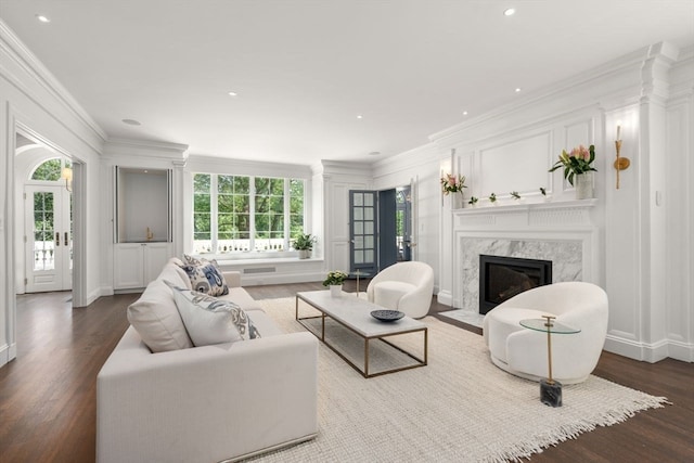 living room featuring ornamental molding, hardwood / wood-style floors, and a fireplace