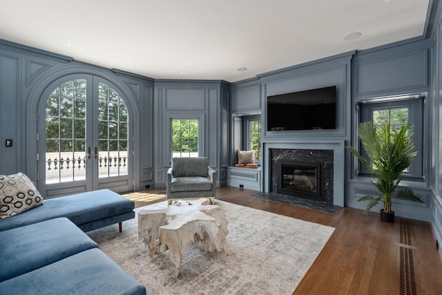 living room with dark hardwood / wood-style floors, french doors, and a fireplace