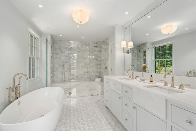 bathroom featuring separate shower and tub, ornamental molding, and vanity