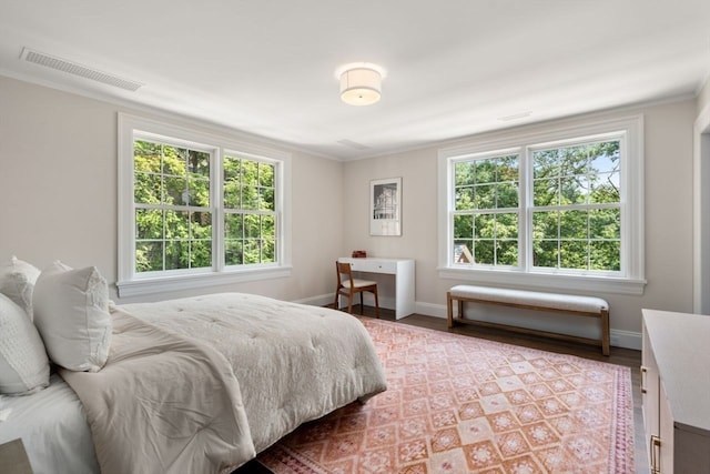 bedroom with crown molding and hardwood / wood-style flooring