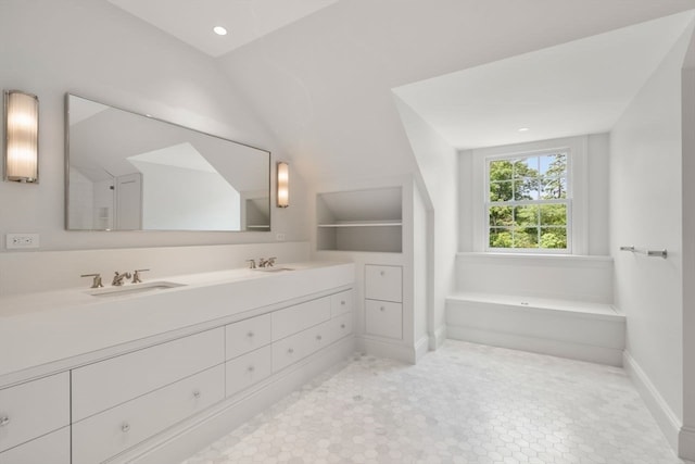 bathroom with a bathing tub and vanity