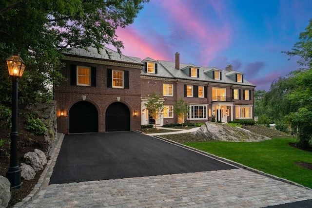 view of front of home featuring a garage and a lawn