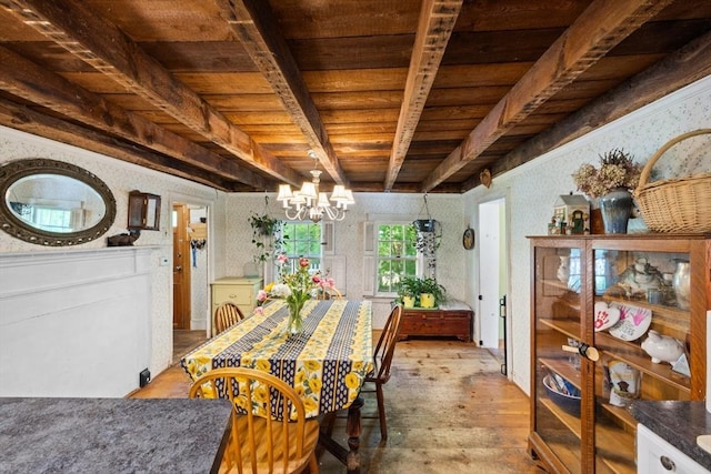 dining room with wooden ceiling, wood-type flooring, a chandelier, beam ceiling, and wallpapered walls