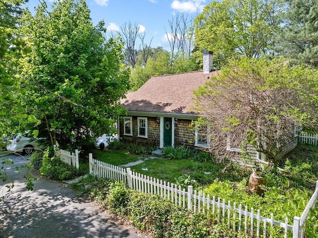 view of front of property with roof with shingles and a chimney