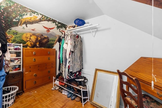 walk in closet with vaulted ceiling