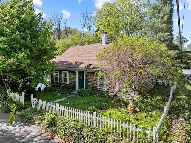 view of front of property featuring a chimney and roof with shingles