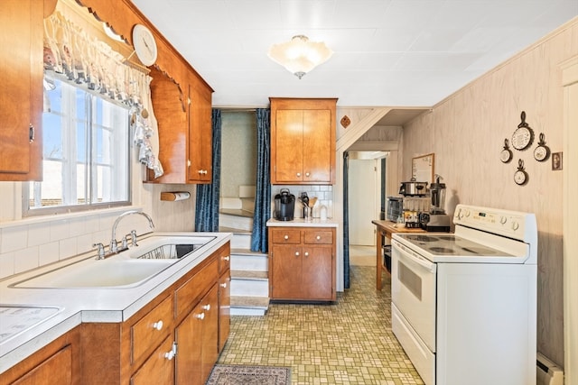 kitchen featuring white range with electric stovetop, tasteful backsplash, baseboard heating, light tile floors, and sink