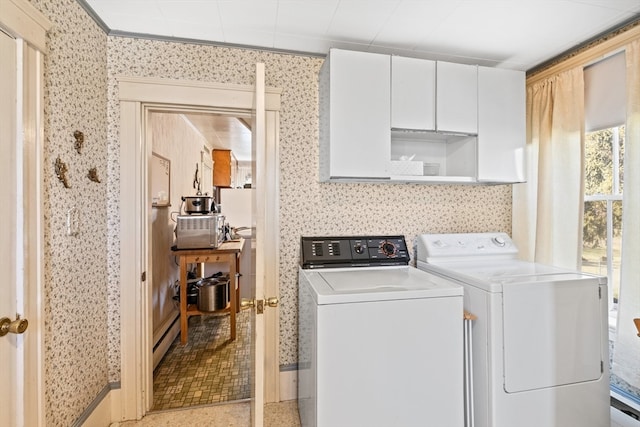 laundry area featuring separate washer and dryer and cabinets