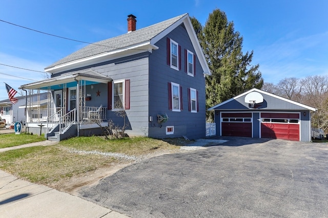 view of front of property with a porch, an outdoor structure, and a garage