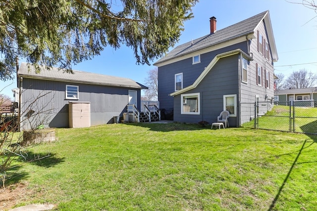 rear view of house featuring a lawn