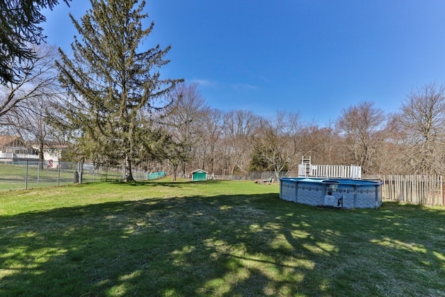 view of yard with a fenced in pool