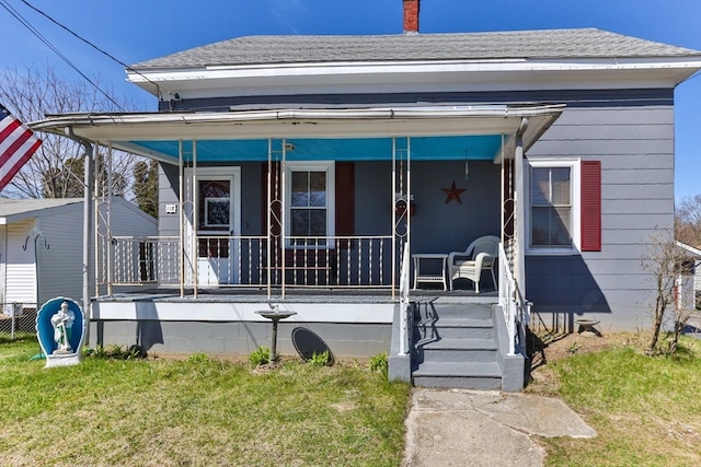 bungalow featuring a porch and a front yard