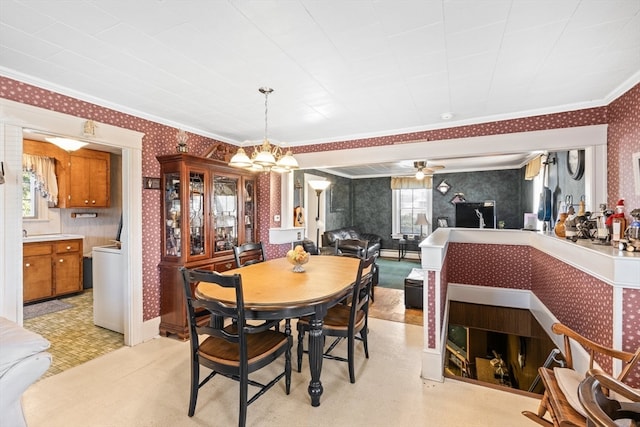 dining area featuring crown molding, a wealth of natural light, a baseboard radiator, and ceiling fan with notable chandelier