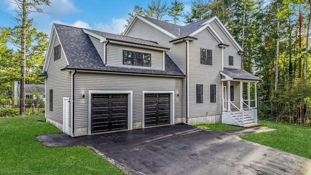 view of front property featuring a garage and a front lawn