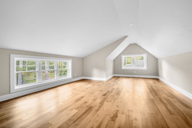 bonus room with light hardwood / wood-style floors, lofted ceiling, and plenty of natural light