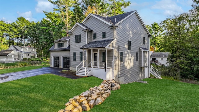 view of property with a front lawn and a garage