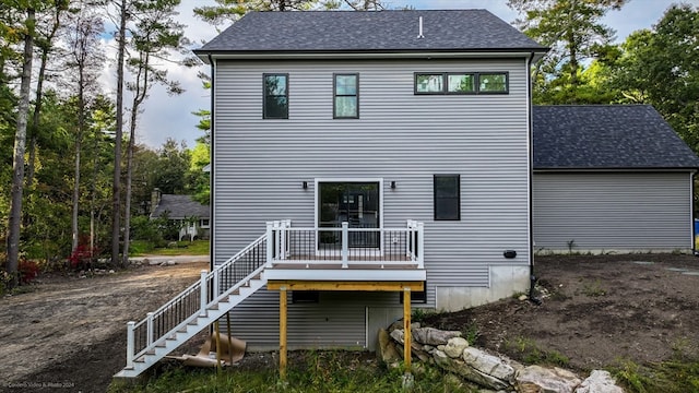 rear view of property with a wooden deck