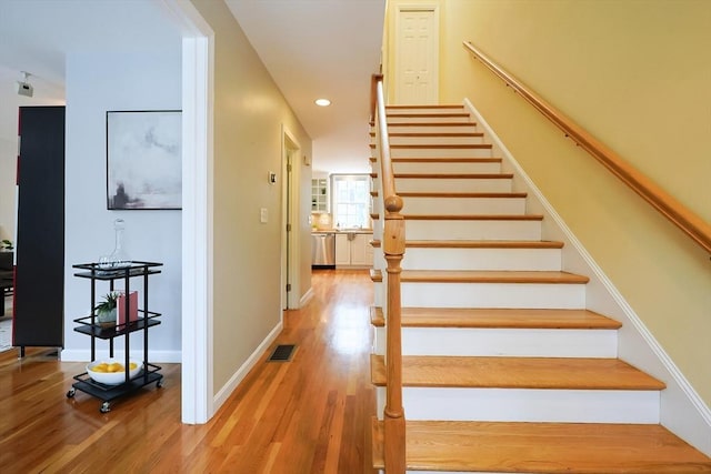 staircase featuring hardwood / wood-style flooring