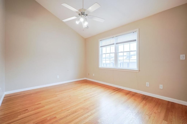 empty room featuring ceiling fan, light wood-type flooring, and lofted ceiling