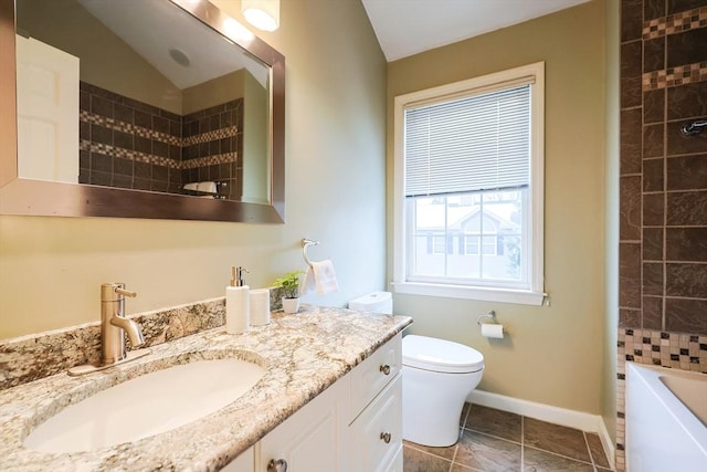 full bathroom featuring vanity, tile patterned floors, vaulted ceiling, tiled shower / bath combo, and toilet