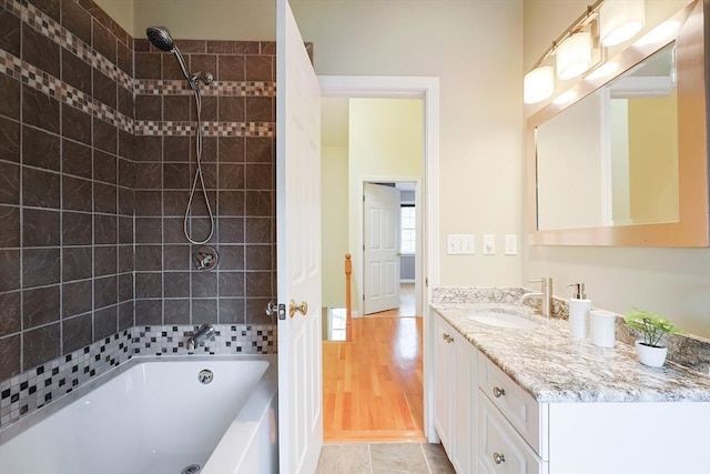 bathroom with vanity, tiled shower / bath combo, and tile patterned floors